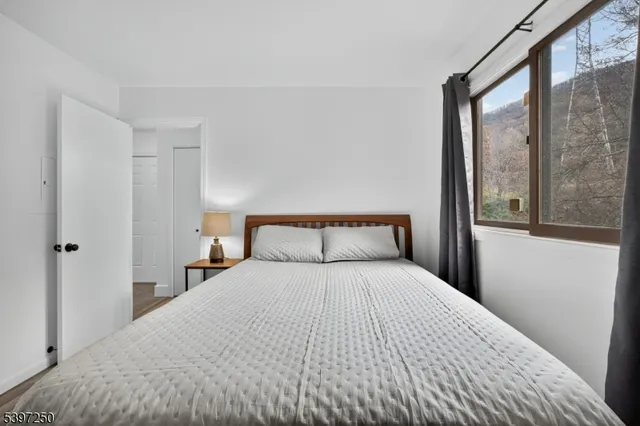 a bedroom with a large bed and a large window