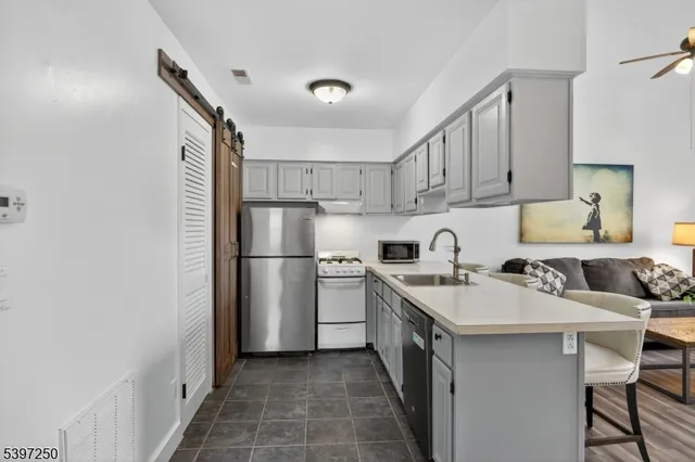 a kitchen with a sink cabinets and stainless steel appliances