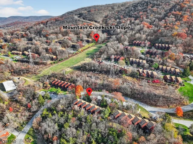 an aerial view of street and residential houses