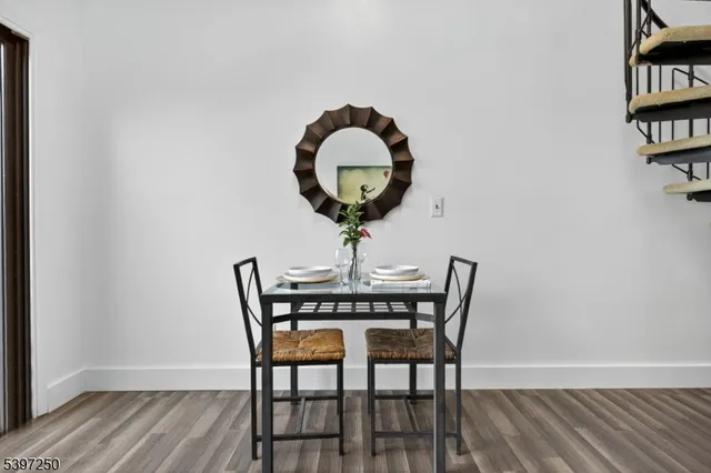 a sitting area with furniture and wooden floor