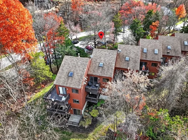 an aerial view of a house with garden space and street view