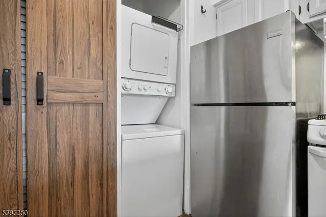 a white refrigerator freezer and a stove sitting inside of a kitchen