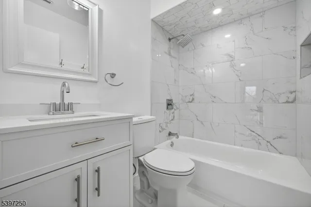 a bathroom with a sink a toilet and bathtub