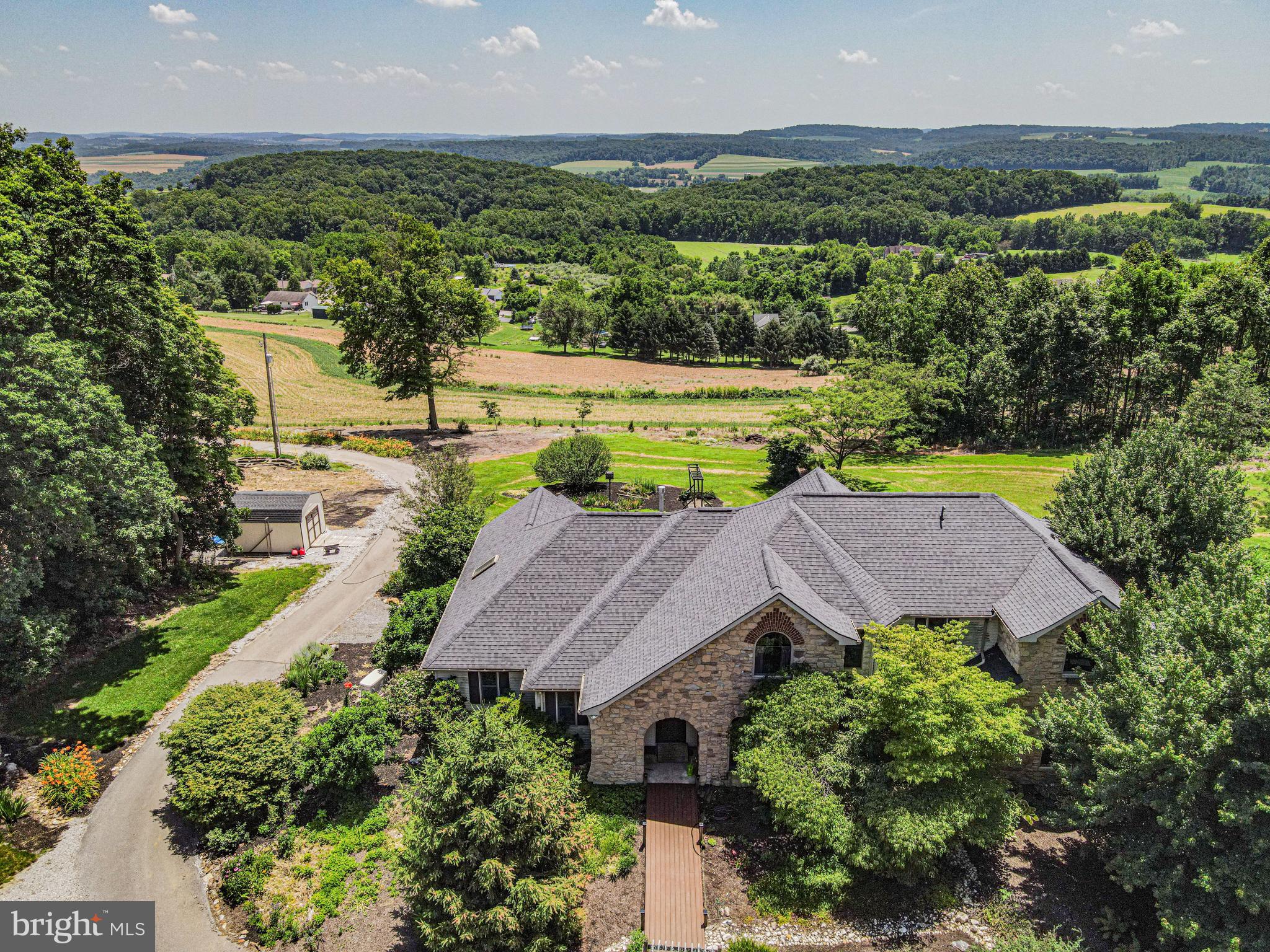 an aerial view of a house with yard swimming pool and outdoor seating
