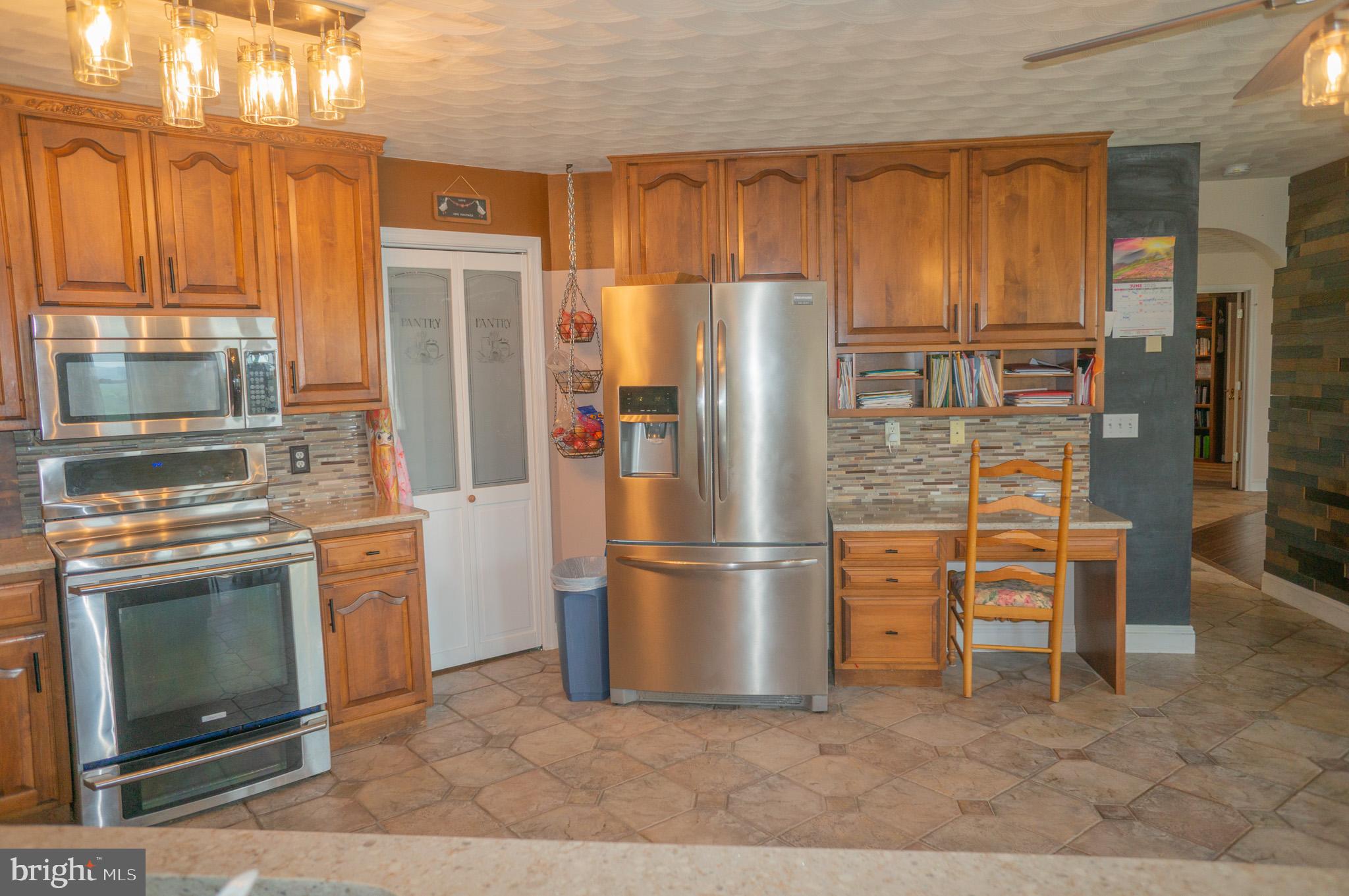4815 Zeiglers Church Road Spring Grove, PA 17362 - Photo 22 of 126 a kitchen with stainless steel appliances granite countertop a refrigerator a stove and a sink with granite countertops