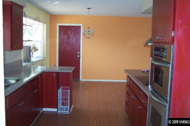 22885 Carriage Drive Reno, NV 89521 - Photo 2 of 5 a kitchen with wooden cabinets