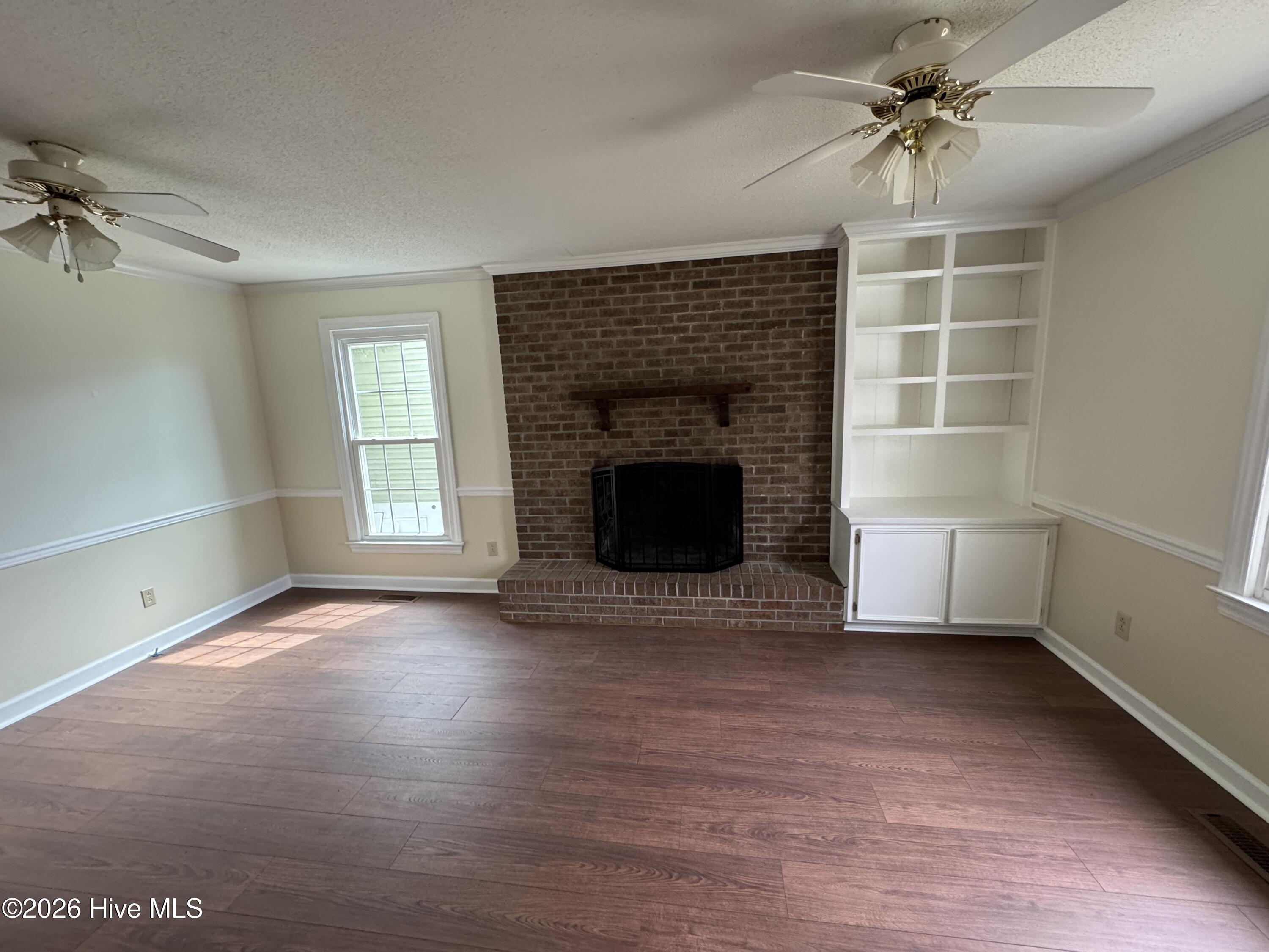 2 Raintree Way Havelock, NC 28532 - Photo 9 of 43 Den w/Fireplace,wood burning. Built in Book Case. Natural light and Two Ceiling Fans