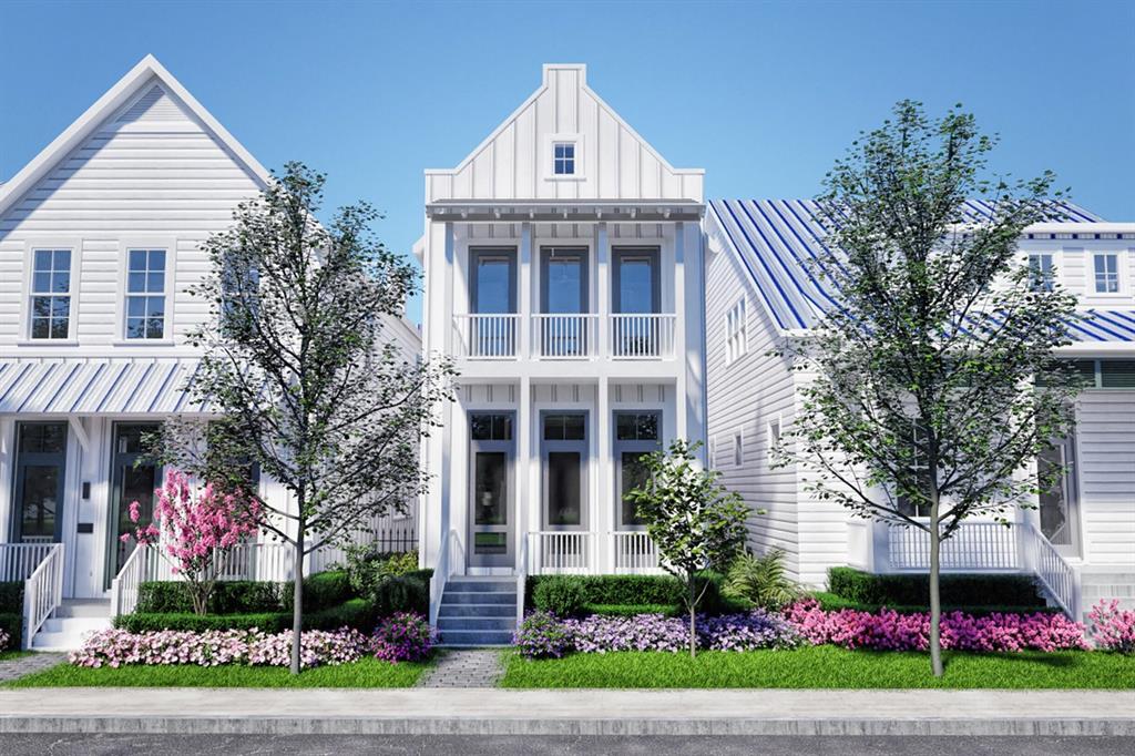 a front view of a house with a yard and potted plants
