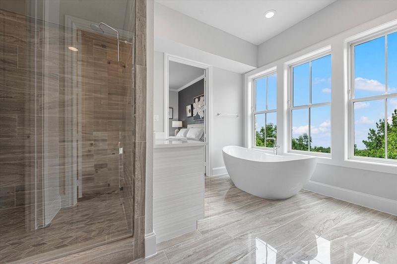 1362 East Crosby Road Carrollton, TX 75006 - Photo 12 of 26 a bathroom with a bathtub and window