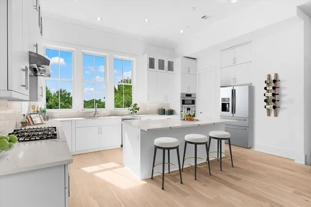 a kitchen with a sink cabinets and wooden floor