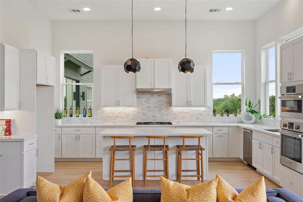 1362 East Crosby Road Carrollton, TX 75006 - Photo 7 of 26 a kitchen with stainless steel appliances granite countertop a stove a sink and a refrigerator