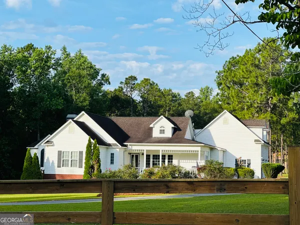 a front view of a house with a garden and plants