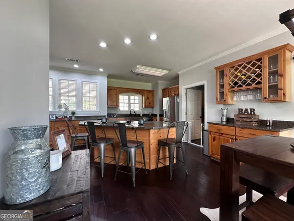 a living room with furniture a large window and a chandelier