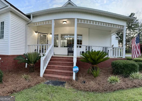 a front view of house with yard outdoor seating and barbeque oven