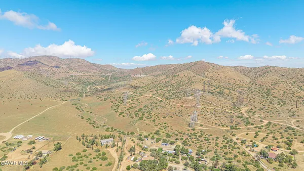 a view of a house with a mountain yard