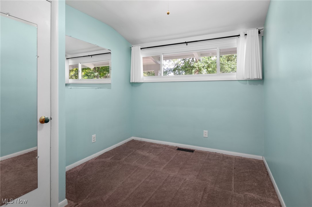 808 Bell Road Chagrin Falls, OH 44022 - Photo 16 of 28 Unfurnished room with dark colored carpet and baseboards