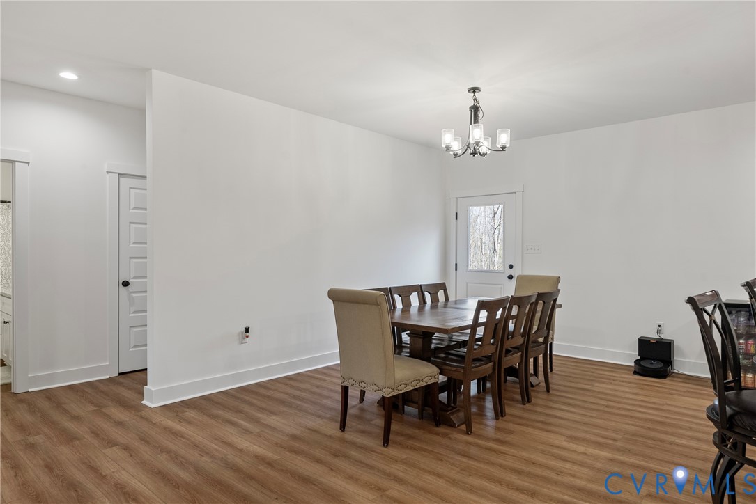4316 Mt Airy Road Louisa, VA 23093 - Photo 12 of 45 a view of a dining room with furniture wooden floor and a chandelier