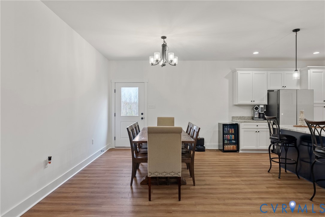4316 Mt Airy Road Louisa, VA 23093 - Photo 13 of 45 a dining room with furniture a chandelier and wooden floor