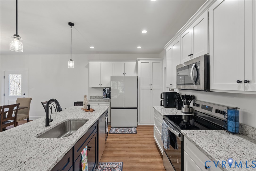 4316 Mt Airy Road Louisa, VA 23093 - Photo 16 of 45 a kitchen with granite countertop a sink stainless steel appliances and cabinets