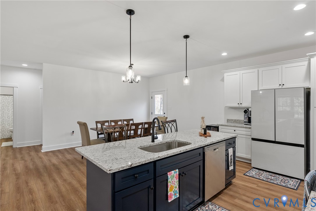 4316 Mt Airy Road Louisa, VA 23093 - Photo 17 of 45 a kitchen with a refrigerator a sink and wooden floor