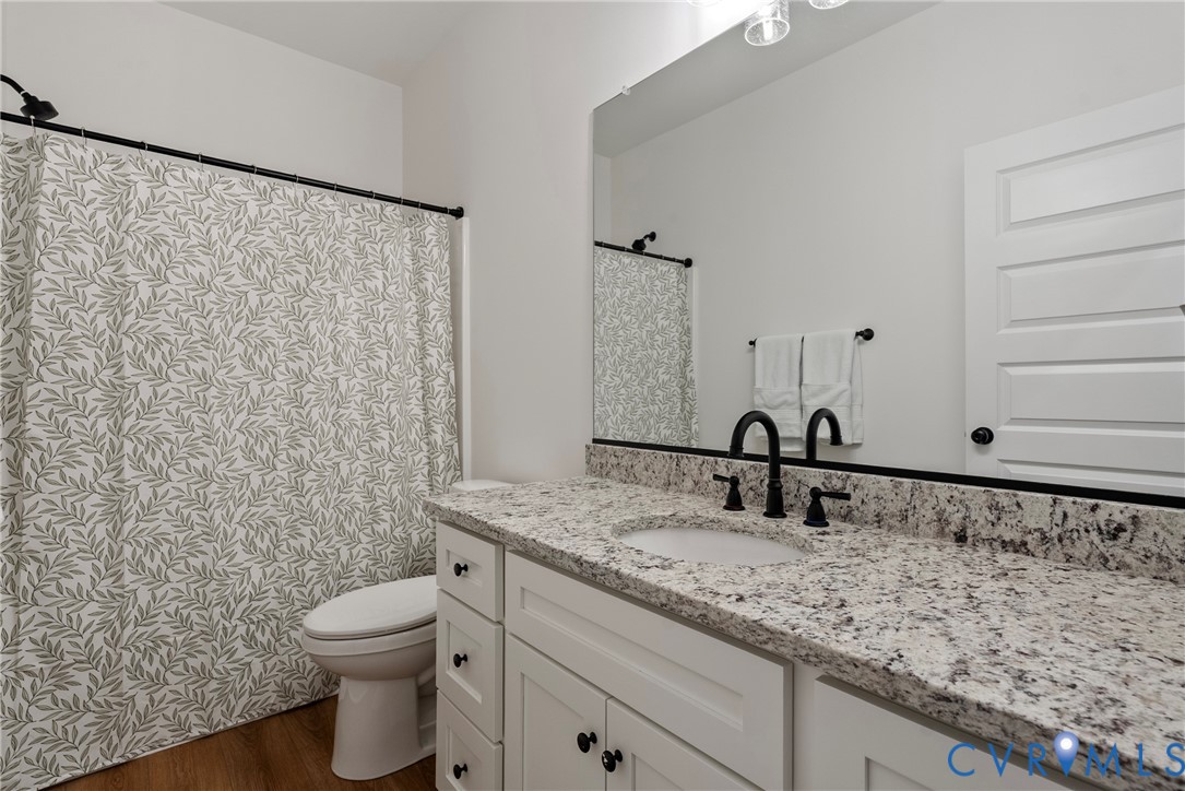 4316 Mt Airy Road Louisa, VA 23093 - Photo 22 of 45 a bathroom with a granite countertop sink and a mirror