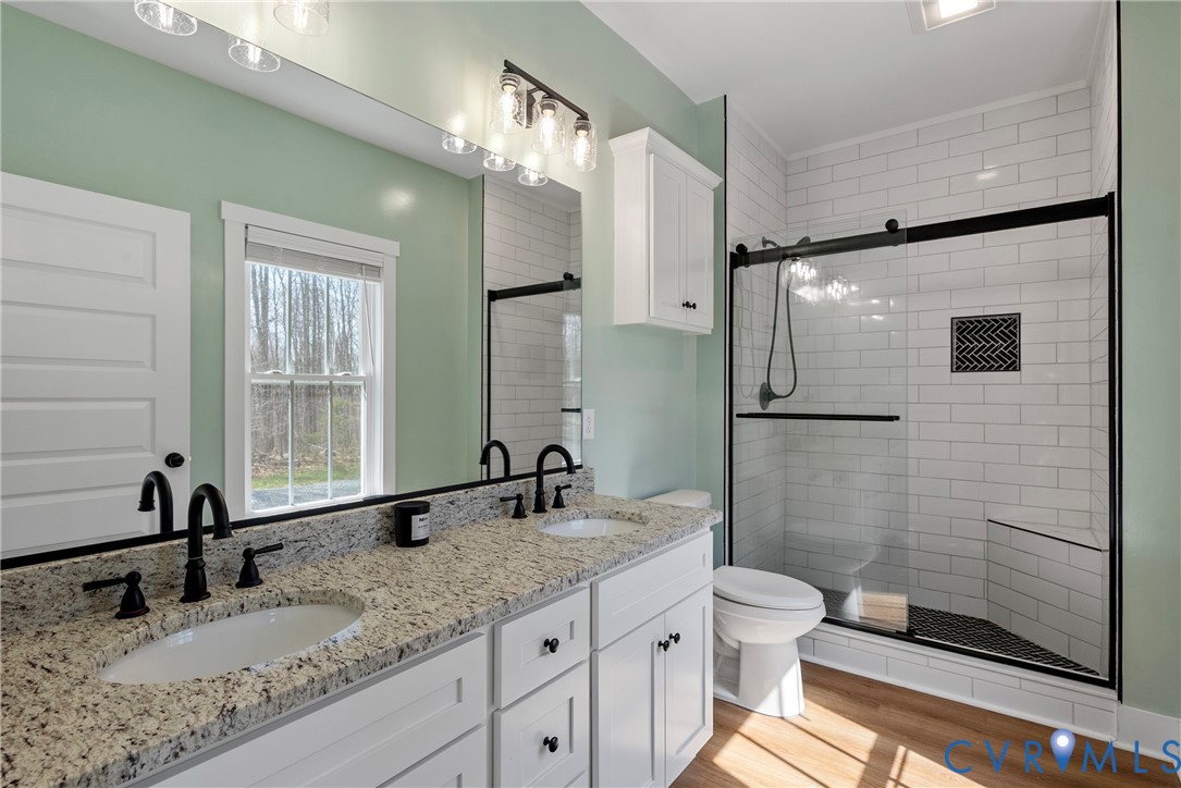 4316 Mt Airy Road Louisa, VA 23093 - Photo 29 of 45 a bathroom with a double vanity sink toilet mirror and shower