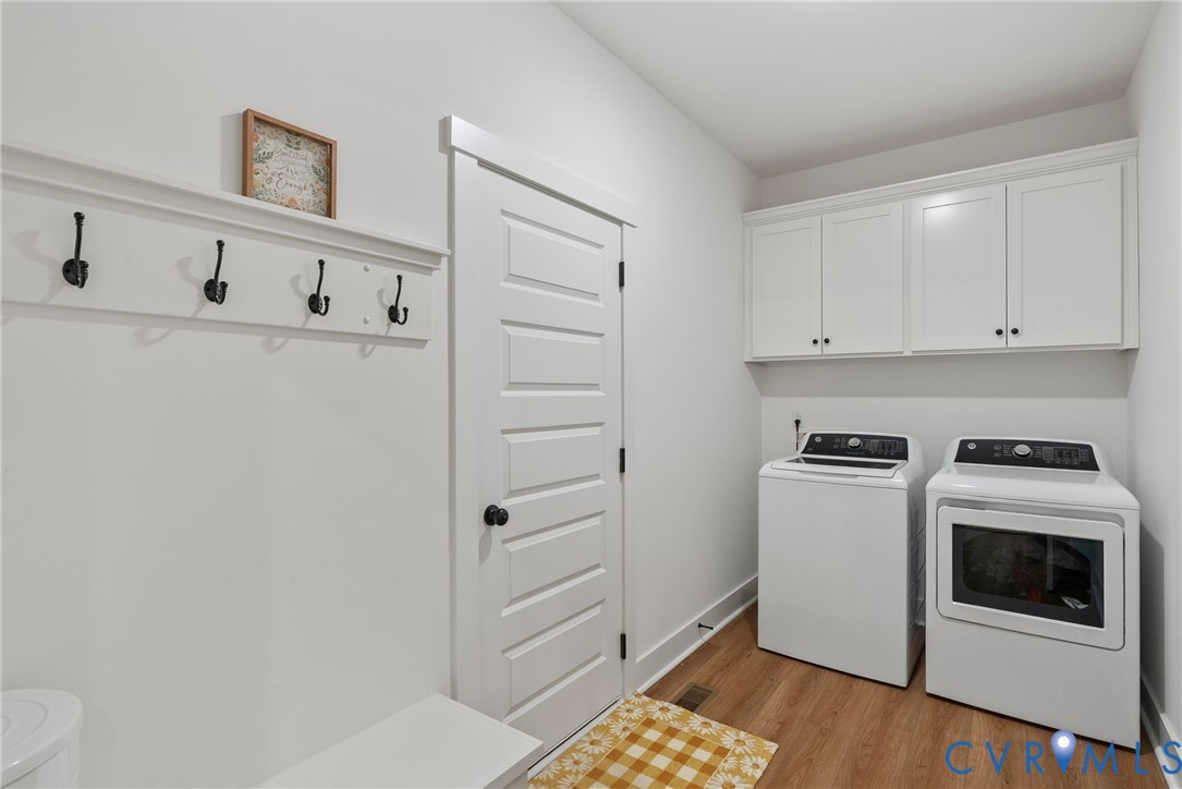 4316 Mt Airy Road Louisa, VA 23093 - Photo 31 of 45 a kitchen with cabinets and white appliances