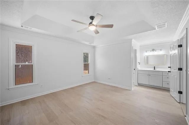 a view of an empty room with window and cabinet
