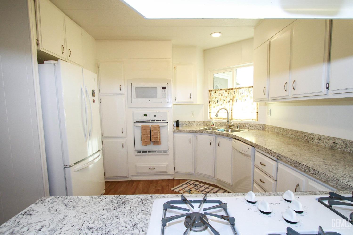 Undisclosed Address Bakersfield, CA 93301 - Photo 11 of 27 a kitchen with stainless steel appliances granite countertop a sink refrigerator and cabinets