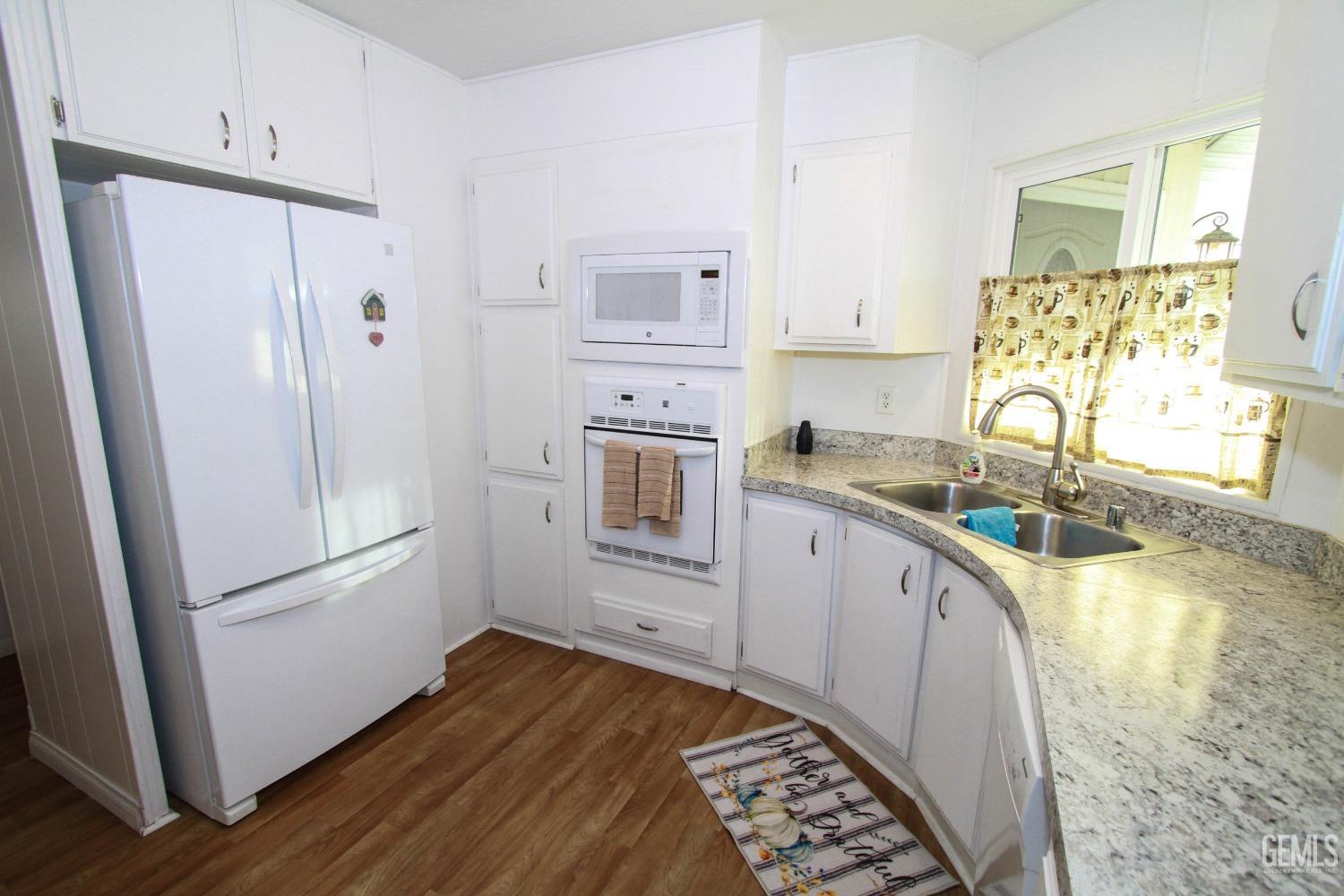Undisclosed Address Bakersfield, CA 93301 - Photo 12 of 27 a kitchen with stainless steel appliances granite countertop a refrigerator and a sink
