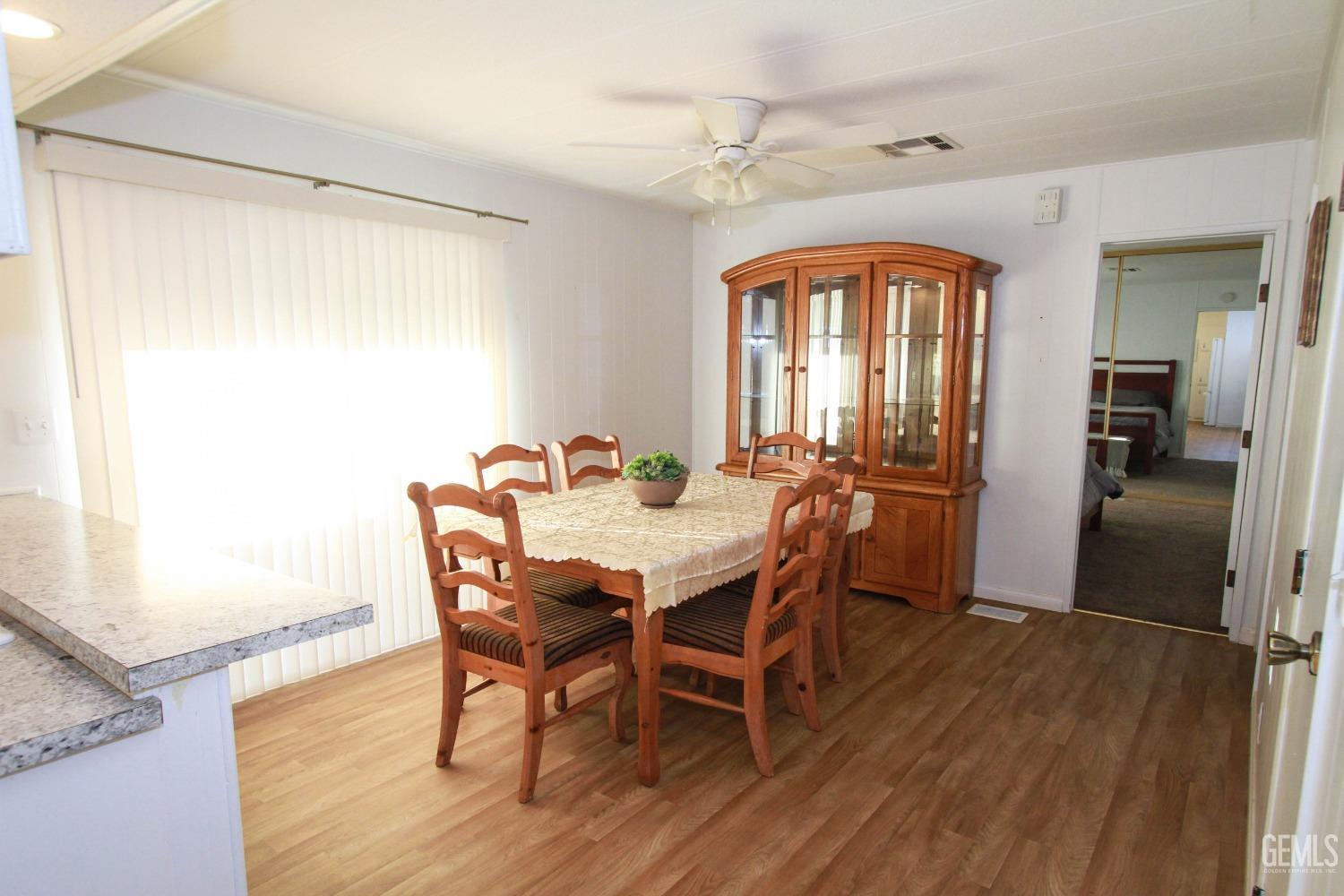 Undisclosed Address Bakersfield, CA 93301 - Photo 14 of 27 a view of a dining room with furniture window and wooden floor