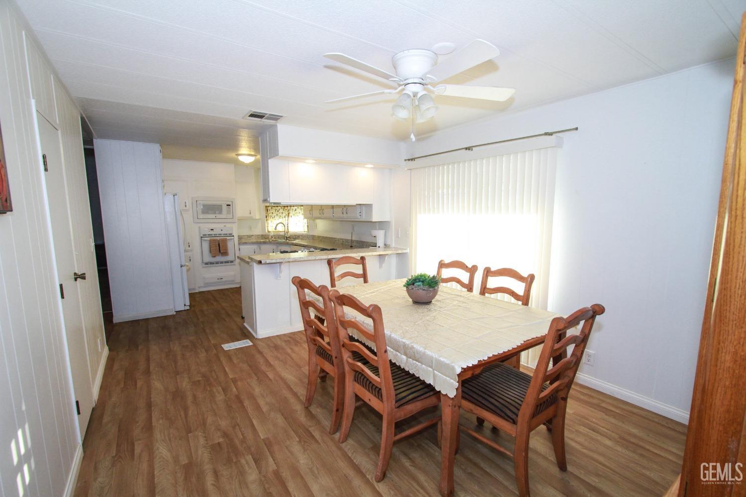 Undisclosed Address Bakersfield, CA 93301 - Photo 15 of 27 a view of a dining room with furniture and wooden floor