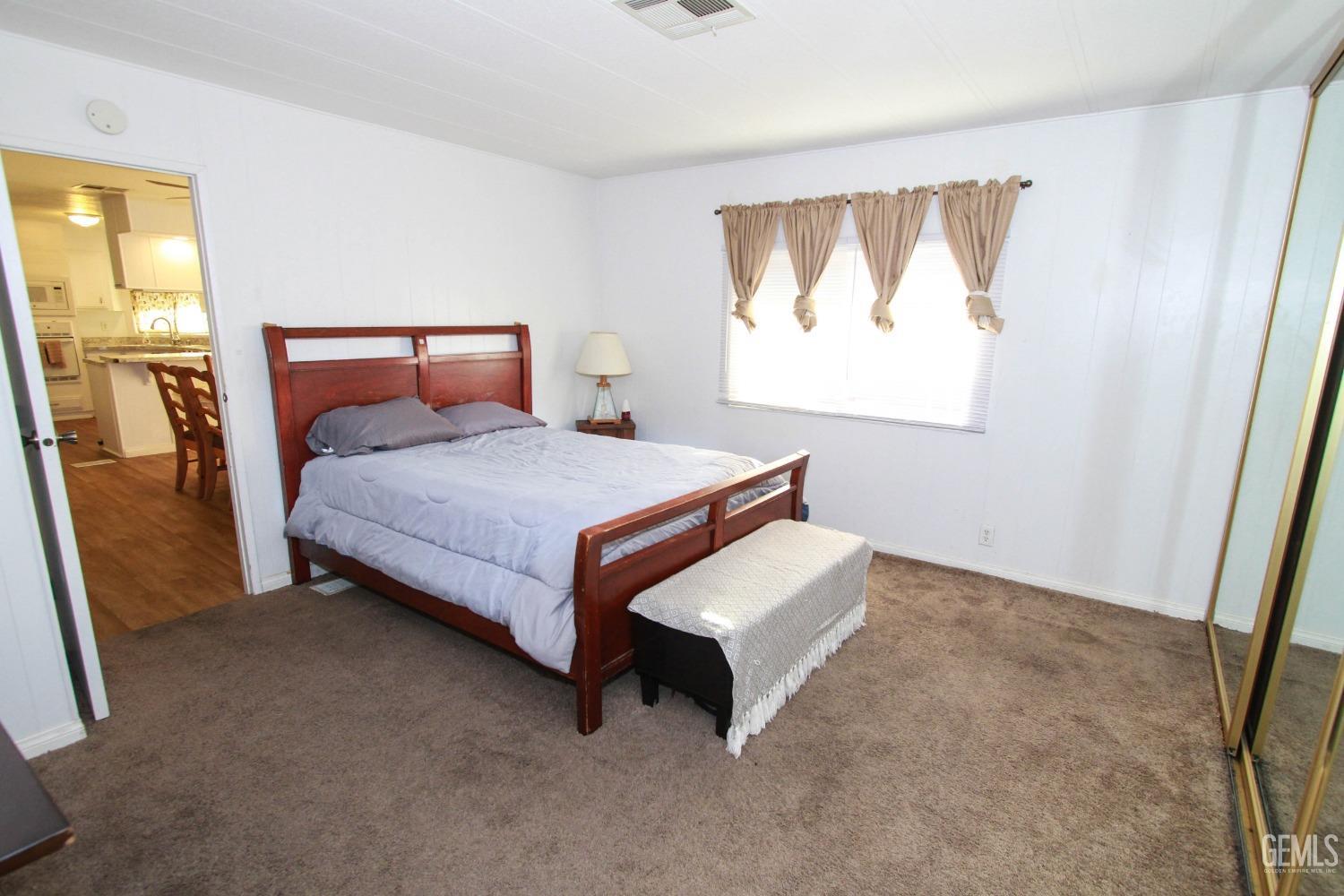 Undisclosed Address Bakersfield, CA 93301 - Photo 18 of 27 a bedroom with a bed and window