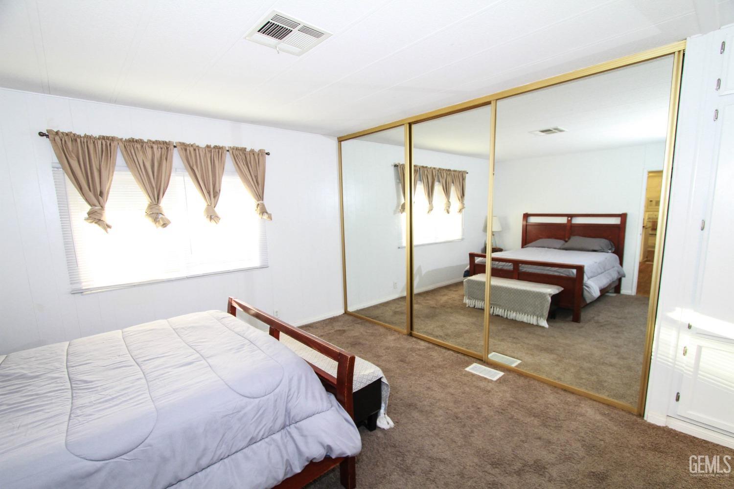 Undisclosed Address Bakersfield, CA 93301 - Photo 19 of 27 a bedroom with a bed and a window