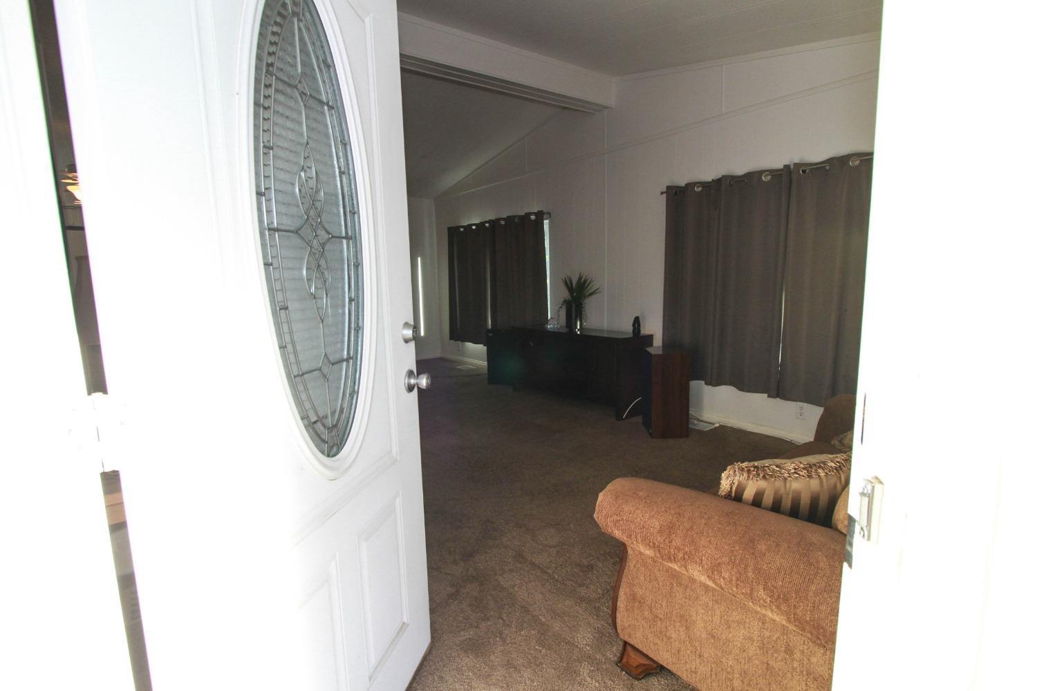 Undisclosed Address Bakersfield, CA 93301 - Photo 3 of 27 a living room with furniture and a gate