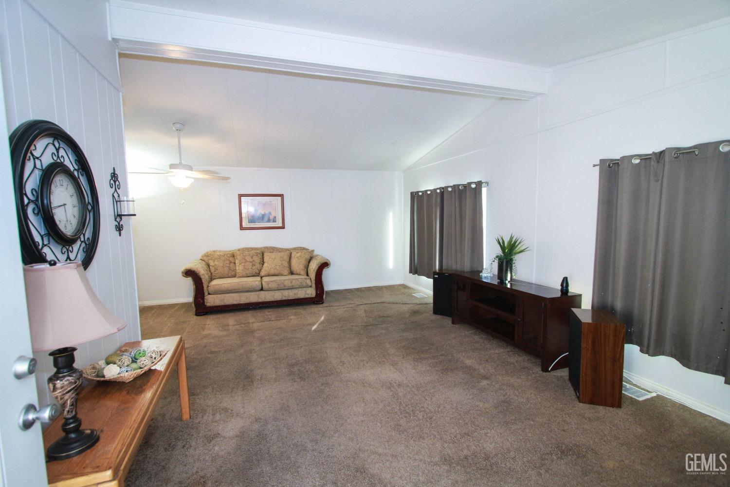 Undisclosed Address Bakersfield, CA 93301 - Photo 4 of 27 a living room with furniture and a mirror