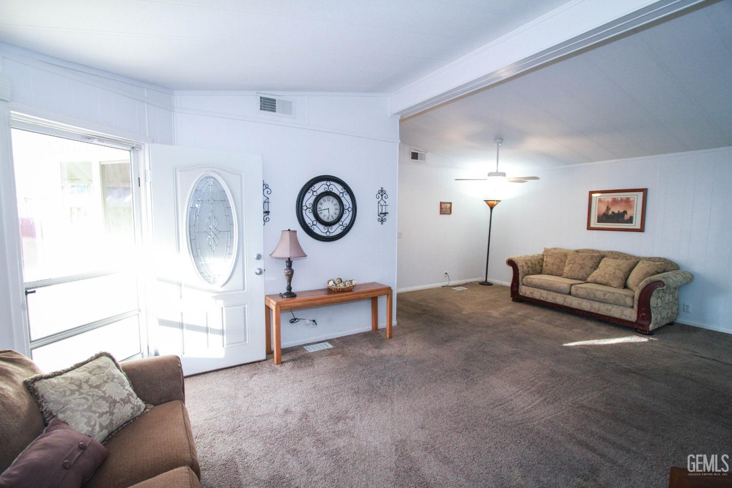 Undisclosed Address Bakersfield, CA 93301 - Photo 5 of 27 a living room with furniture a mirror and a window