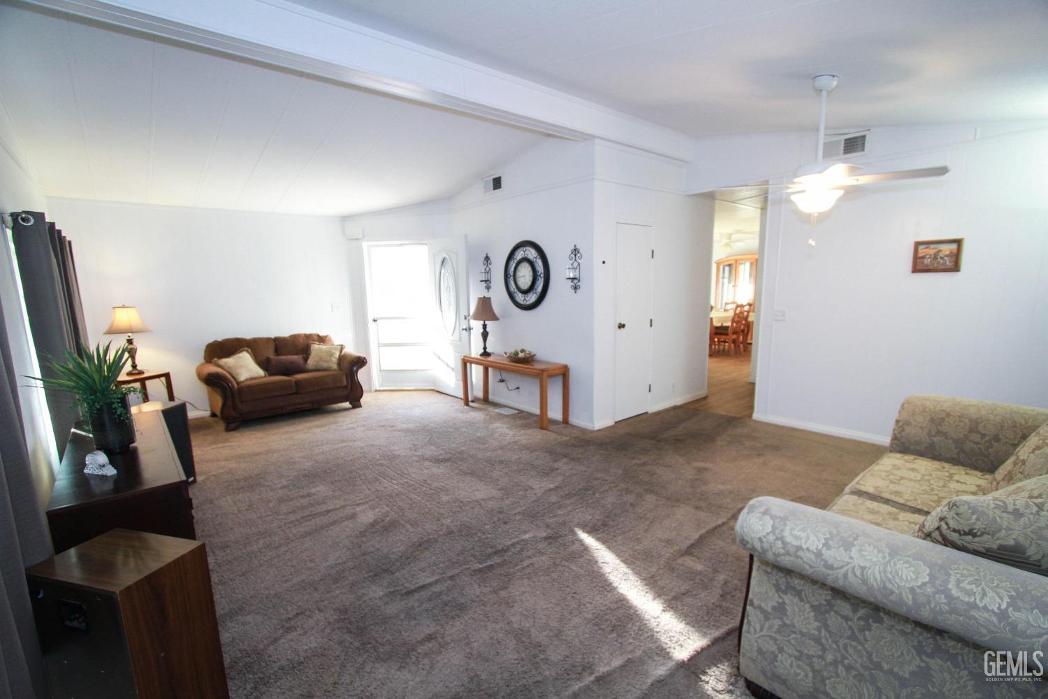Undisclosed Address Bakersfield, CA 93301 - Photo 6 of 27 a living room with furniture and a flat screen tv