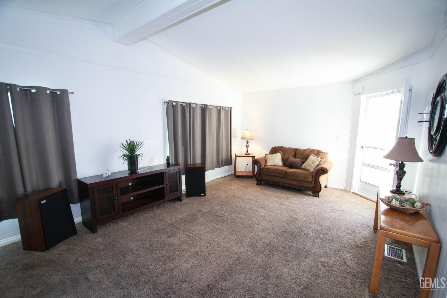 Undisclosed Address Bakersfield, CA 93301 - Photo 7 of 27 a living room with furniture window and a flat screen tv