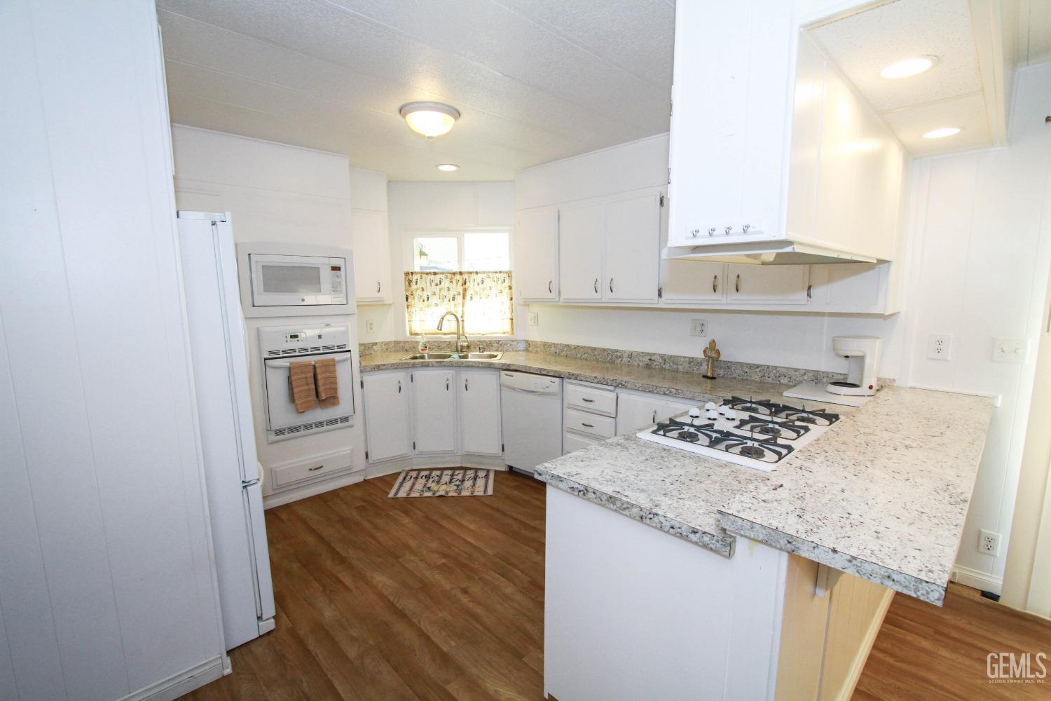Undisclosed Address Bakersfield, CA 93301 - Photo 10 of 27 a kitchen with stainless steel appliances granite countertop a sink stove and refrigerator