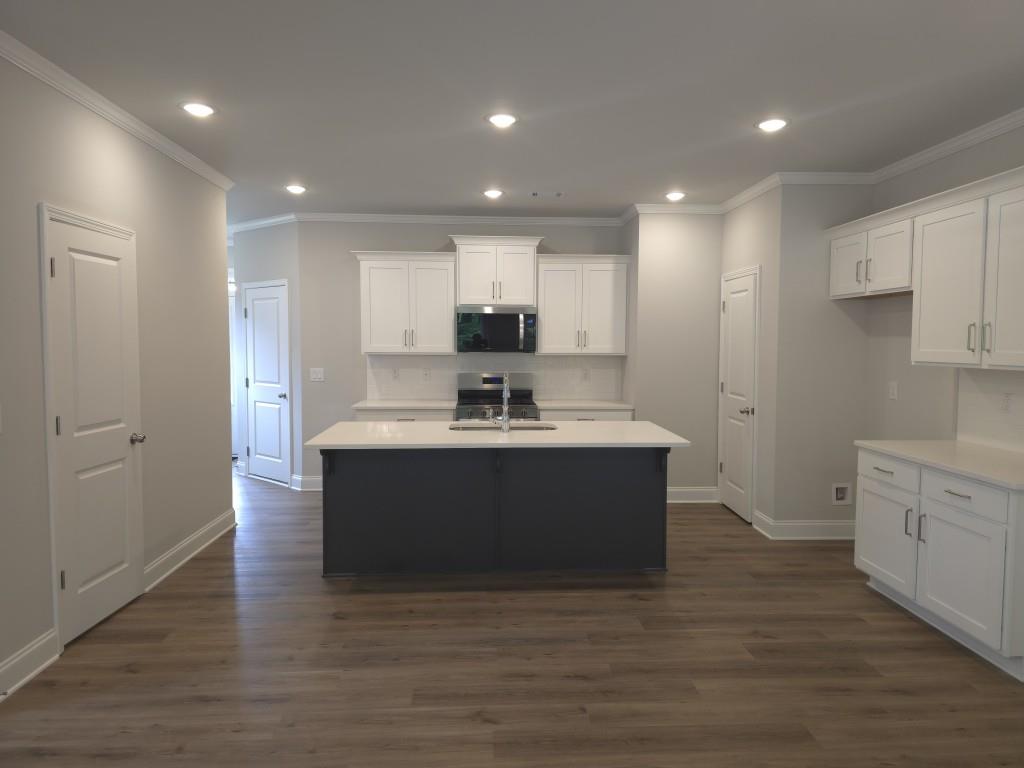 4240 Cavalier Way Duluth, GA 30097 - Photo 8 of 46 a kitchen with stainless steel appliances granite countertop a sink a stove and a refrigerator