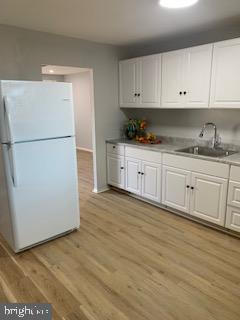 223 Kinsley Road Pemberton, NJ 08068 - Photo 9 of 12 a kitchen with granite countertop white cabinets and white appliances