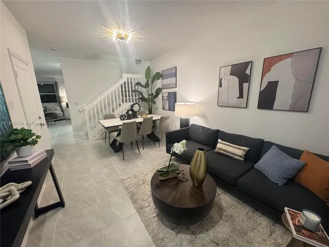 a living room with furniture and a rug