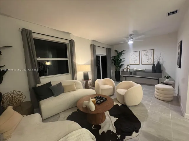 a living room with furniture and a large window