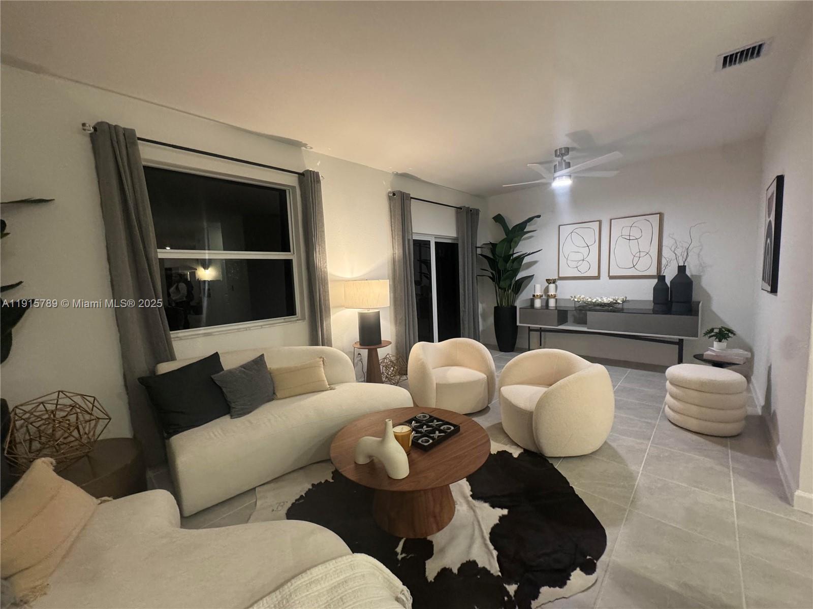 2738 Southeast 24th Terrace Homestead, FL 33035 - Photo 2 of 10 a living room with furniture and a large window