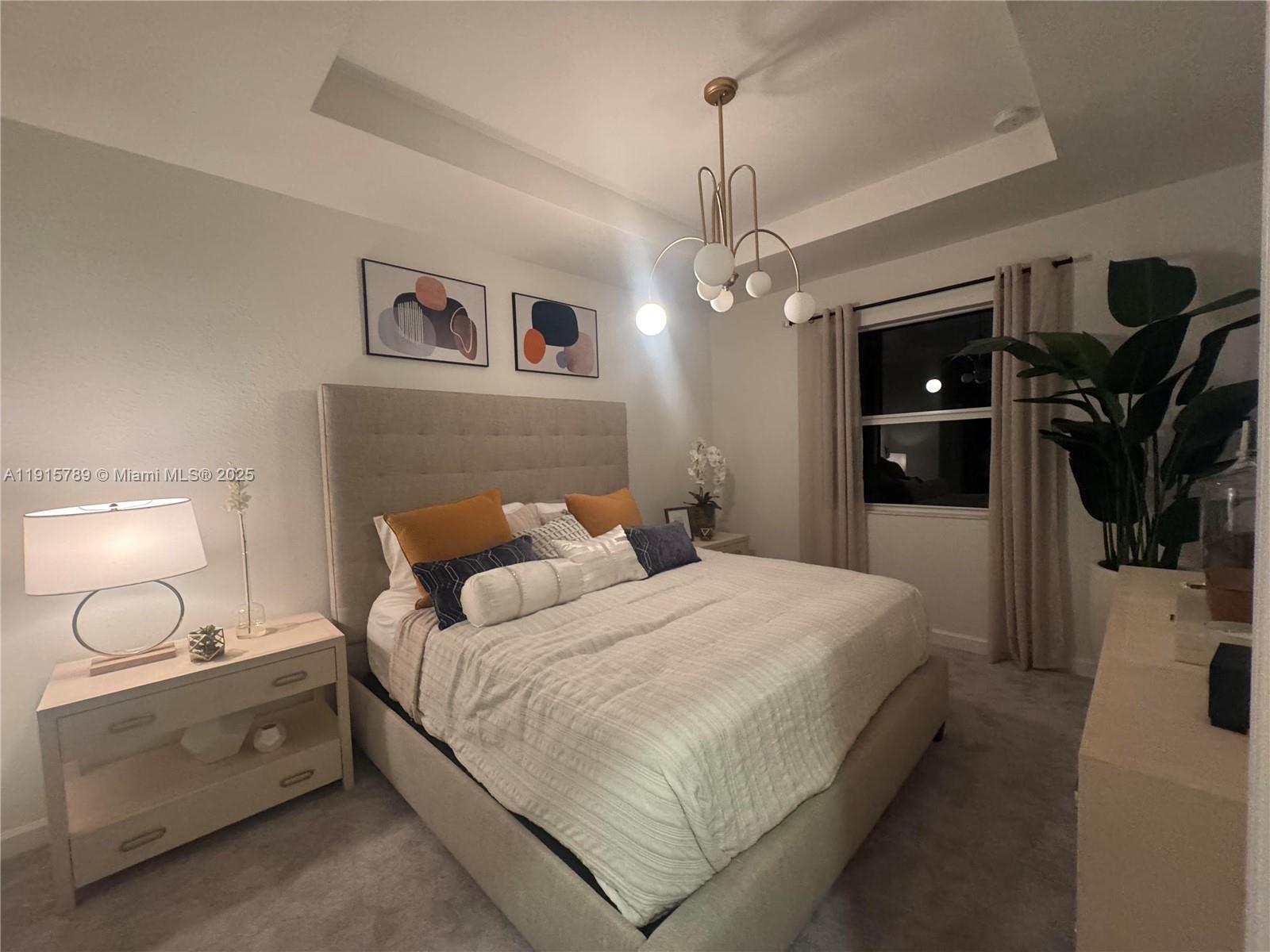 2738 Southeast 24th Terrace Homestead, FL 33035 - Photo 6 of 10 a bedroom with bed and a chandelier