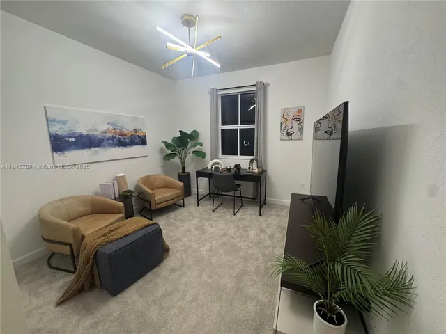 a living room with furniture potted plant and a flat screen tv