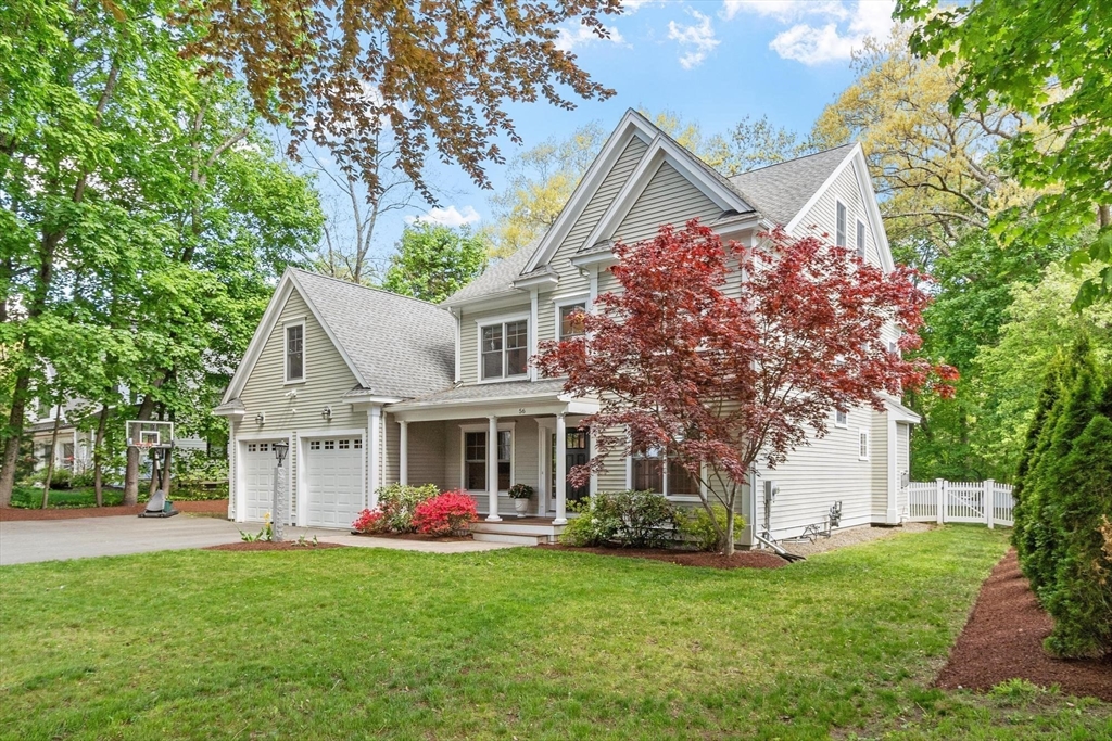56 Old Marlboro Road Concord, MA 01742 - Photo 30 of 34 a front view of a house with a garden and trees