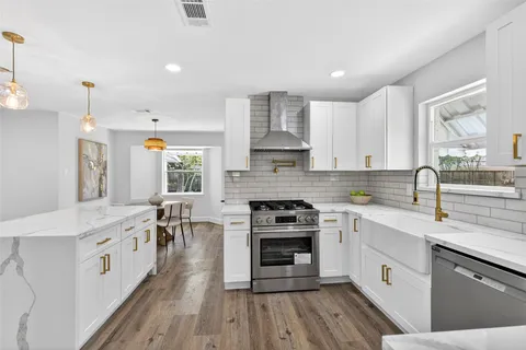 a kitchen with a sink stove top oven and cabinets
