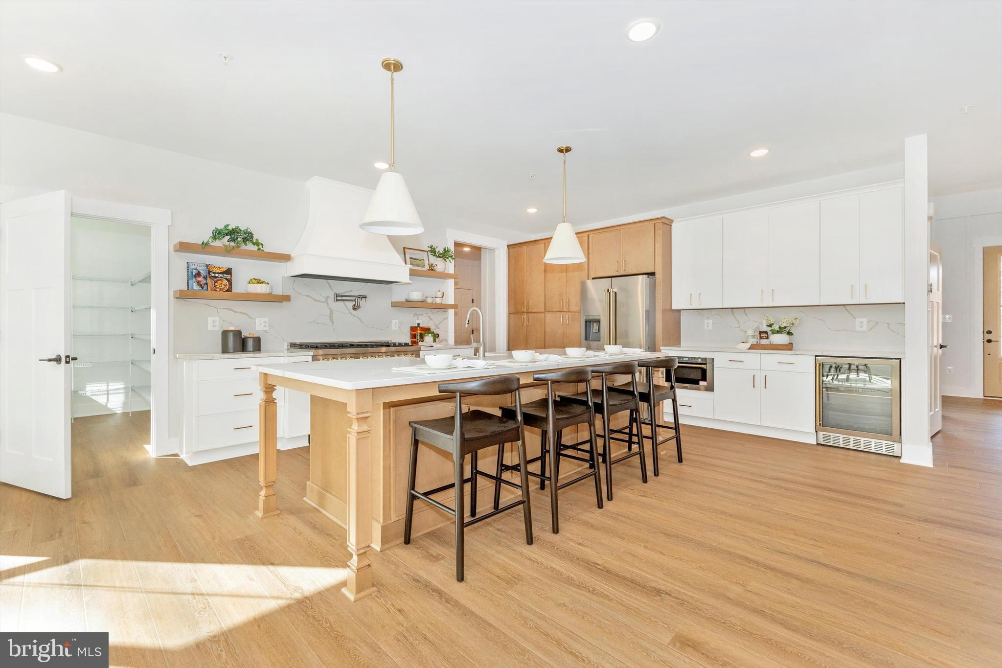 1199 Hoods Mill Road Cooksville, MD 21723 - Photo 11 of 86 a kitchen with stainless steel appliances kitchen island granite countertop a table chairs and a refrigerator